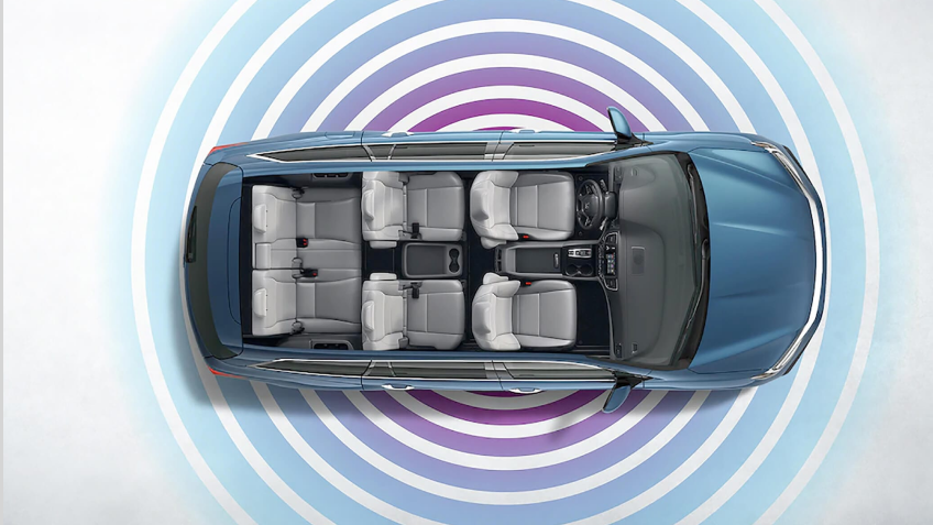 Bird’s eye view of an open roof Honda Pilot on white space with blue and purple Wi-Fi waves emitting radially from it.