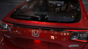Closeup of hatch door on a red Hatchback. 