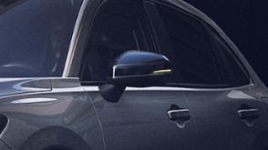 Medium closeup of door mirror on grey HR-V.