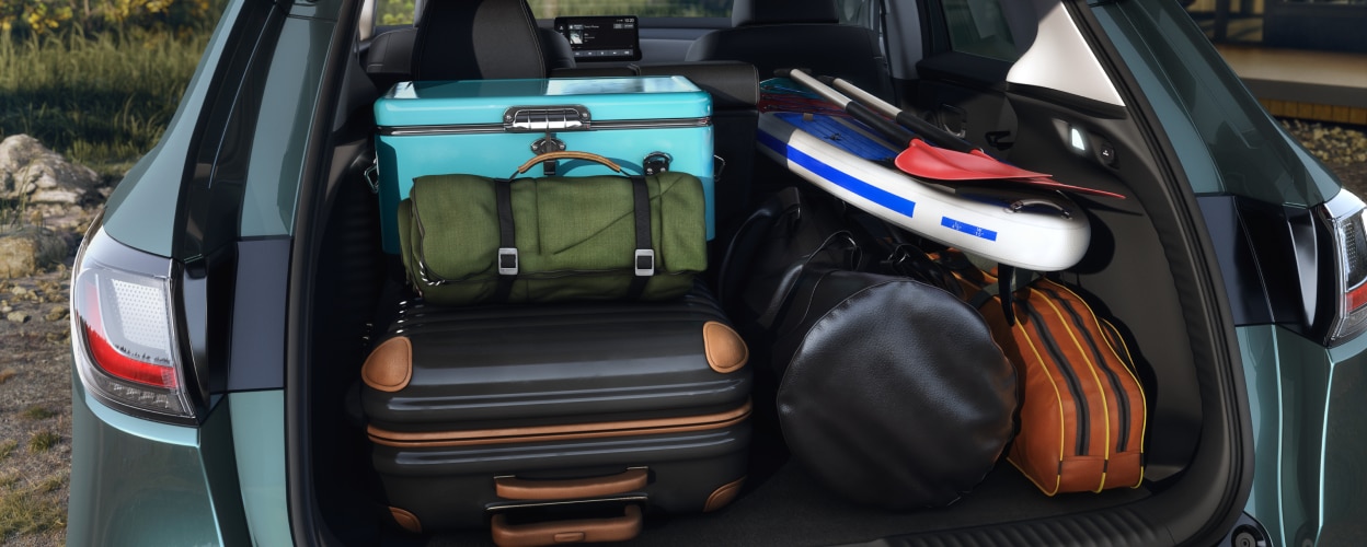 Medium closeup of open tailgate door with the cargo area full of camping and outdoor gear.