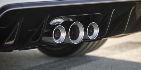 Closeup of the triple centre exhaust on a white Civic Type R.