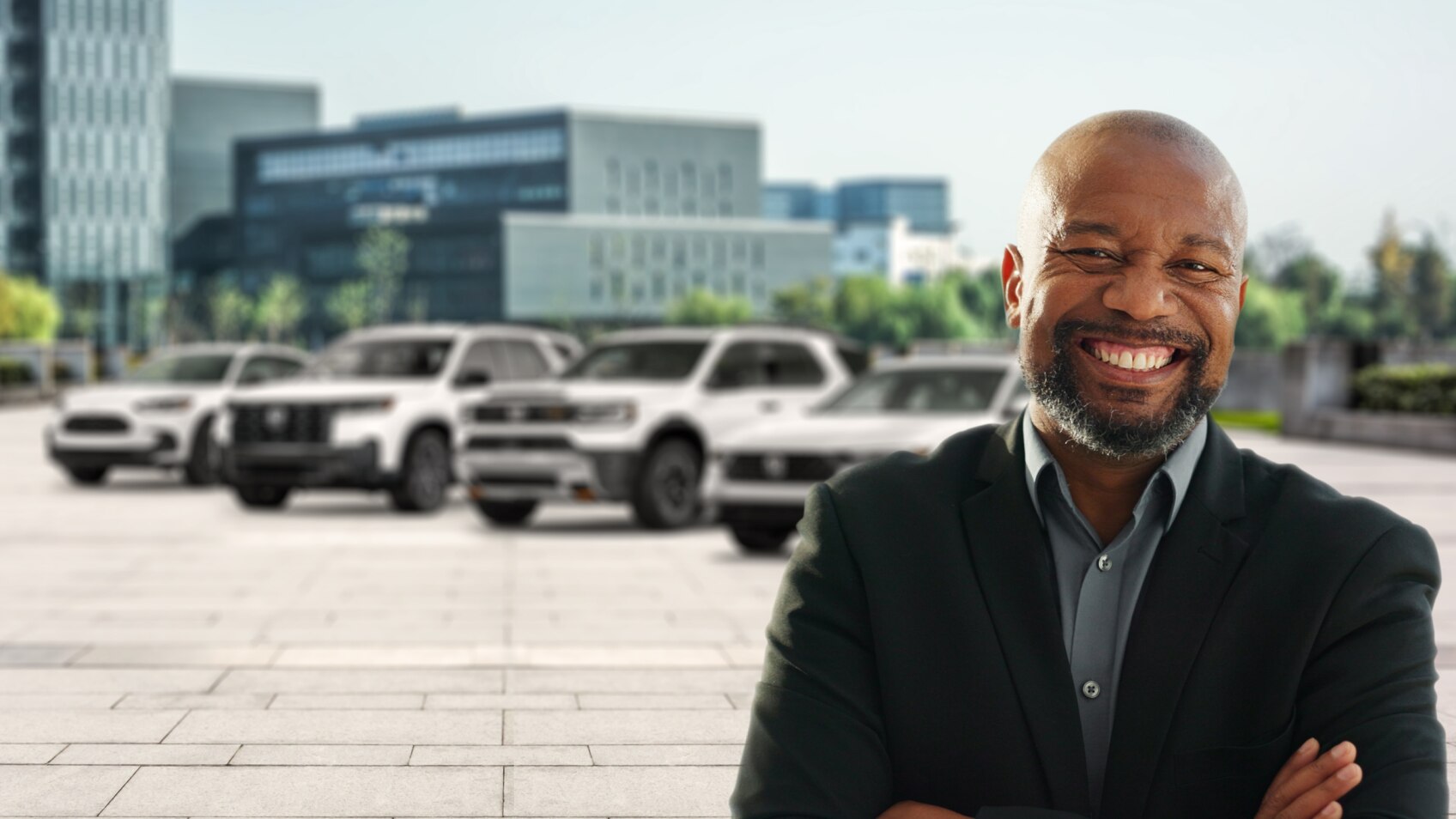 A man standing in front of white Honda models in front of a building