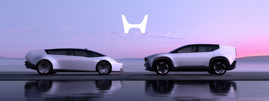 Two white Honda 0 Series vehicles are parked facing one another with their reflections displayed in a large reflecting pool with a pink horizon in the background. 