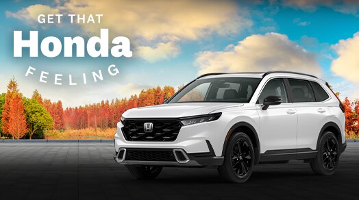 3/4 front view of white CR-V in front of a forest in fall scenery. Headline reads "Get That Honda Feeling.
