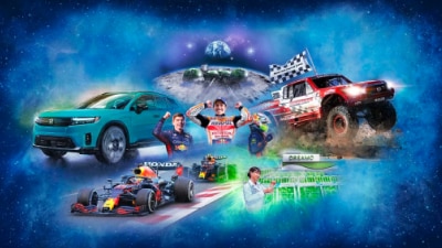 "Honda The Power of Dreams” text in the middle of a space background, surrounded by a nebula and images emerging, centre out, of Honda’s innovations throughout the years: an all-electric SUV, race car drivers, rally trucks, formula one cars, an electric scooter, motorbikes, speedboats, a DREAMO lab technician, a space station on the moon, and more. 