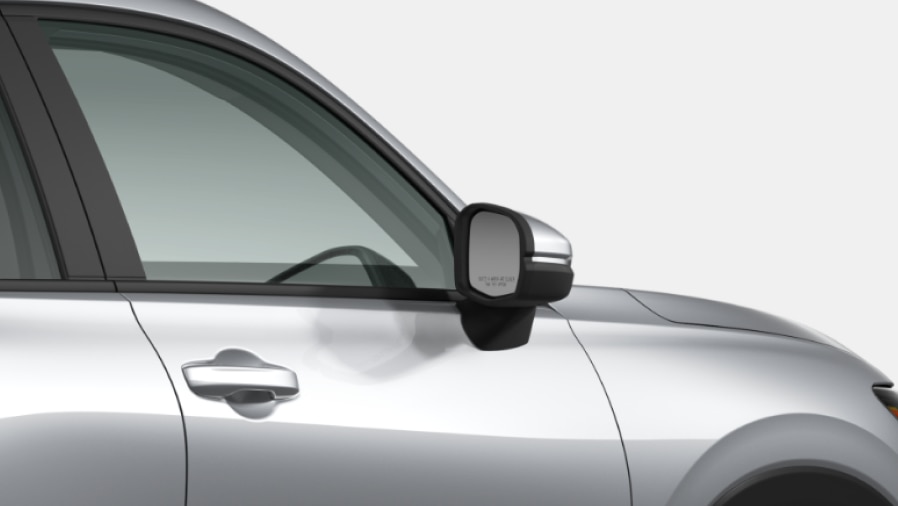 Cropped side-view of the front of a grey Honda set against a white background.