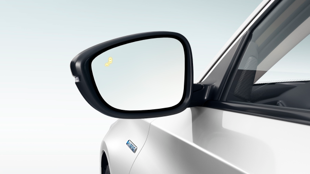 Closeup of side mirror with Blind Spot Indicator light turned on.
