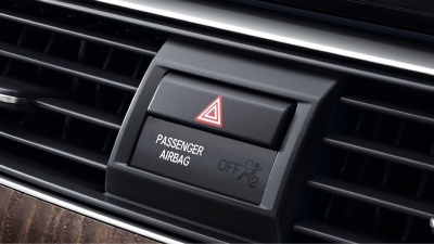 Closeup of airbag indicator light and hazard lights button.