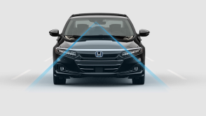 Front view of black Accord Hybrid on white space. Blue sensor lines emit from the front.