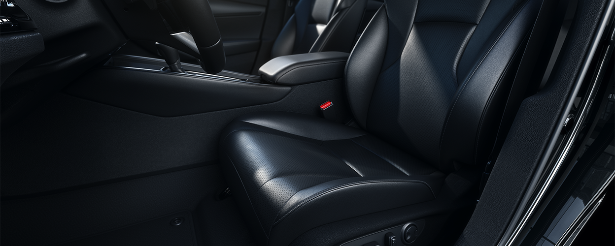 Closeup view of black leather-trimmed driver’s seat.