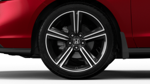Closeup of wheel on a red Accord on white space. 