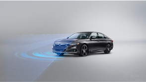 3/4 front view of grey Accord on white space. Blue sensor lines and waves emit from the front. 