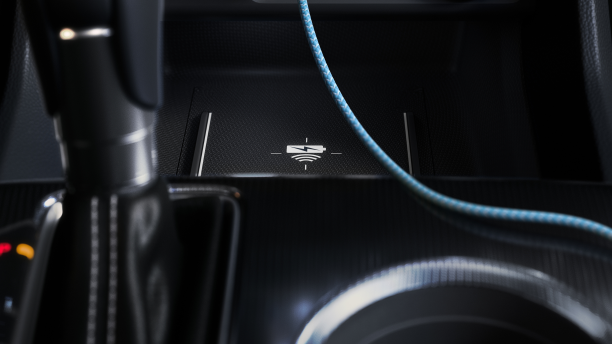 Closeup of wireless charging pad in front of gear shifter. 