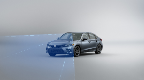 3/4 front view of grey Civic Hatchback. Blue sensor waves and lines emit from the front.