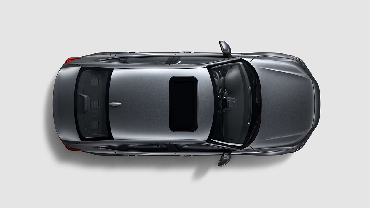 Bird’s eye view looking directly down at a grey Honda Civic Sedan on white space.