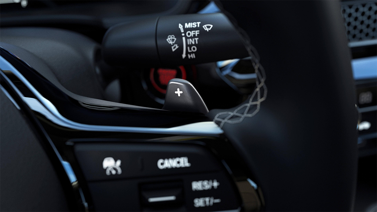 Closeup cruise control accelerator button on steering wheel.