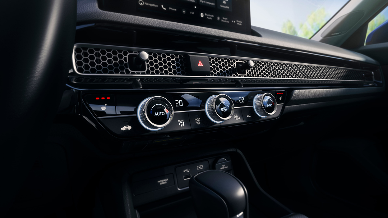 Closeup of the dials and buttons on the climate control.