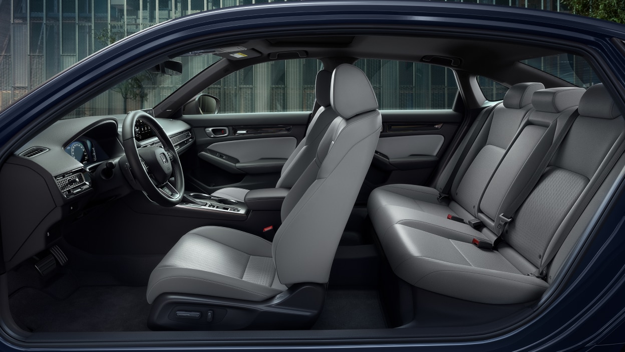 Side panoramic view of a Civic Sedan’s front and rear grey seats.