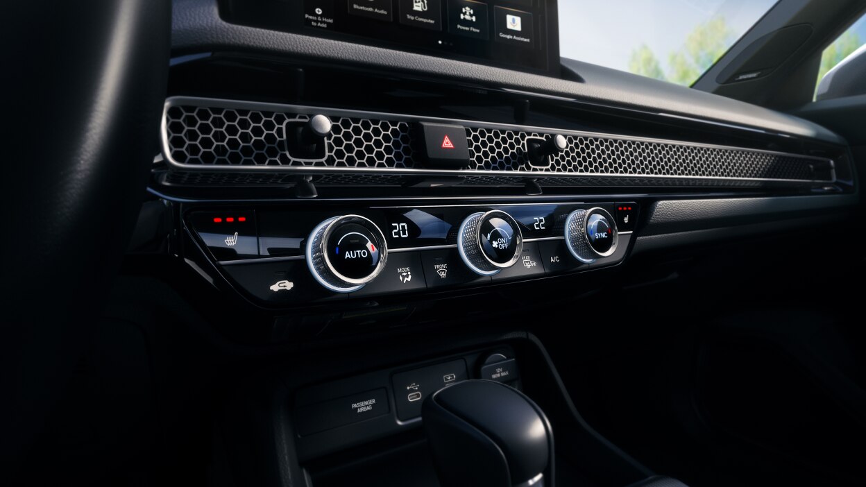 Closeup of the dials and buttons on the climate control.