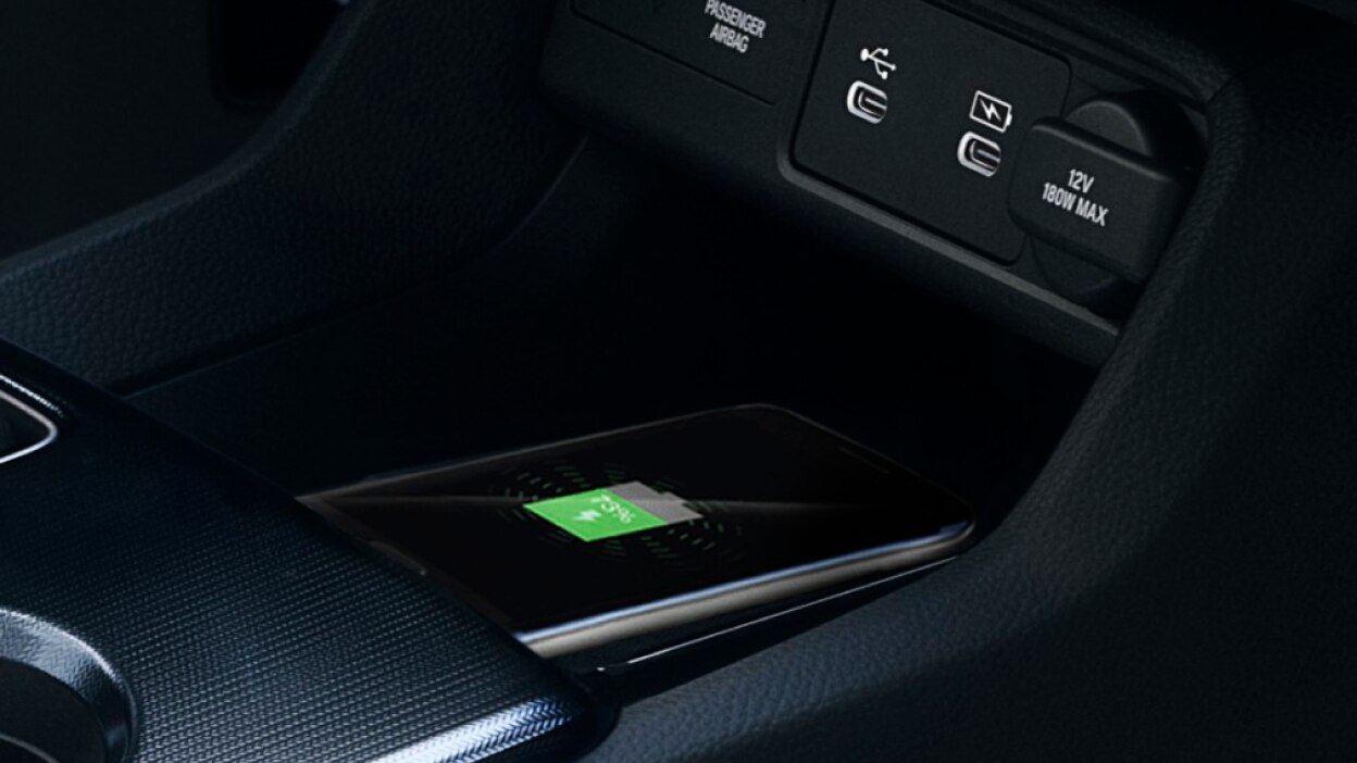 Closeup of phone charging on wireless charging pad.