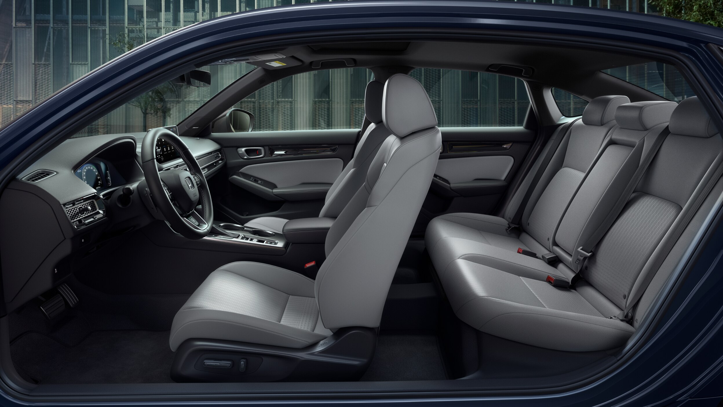 Side panoramic view of a Civic Sedan’s front and rear grey seats.