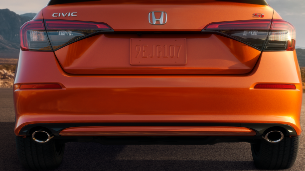 Rear closeup of orange Civic Si. 