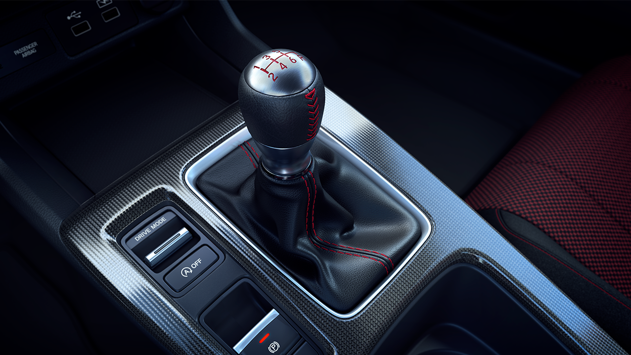 Close up of gear shifter and drive mode toggle.