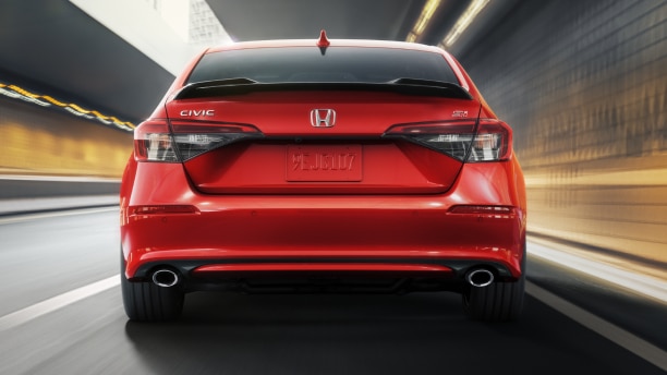 Rearview of red Civic Si driving in tunnel.