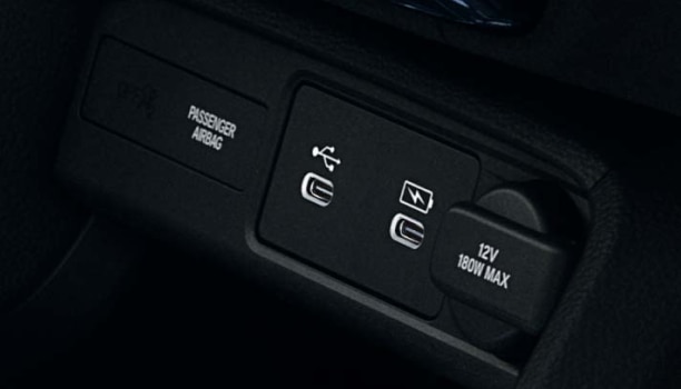 Closeup of USB charging ports in centre console.
