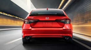 Rearview of red Civic Si driving in tunnel.