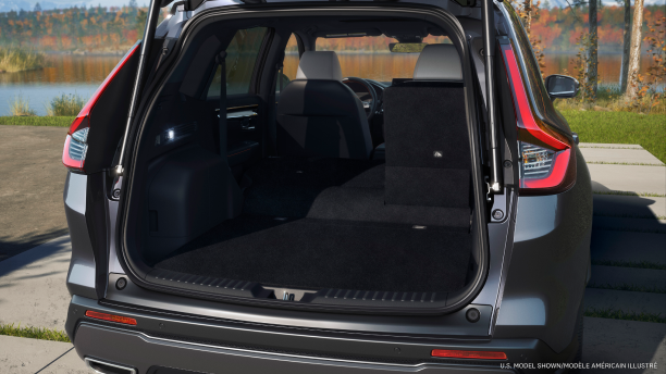 Rear view of open tailgate on a parked grey Honda CR-V; lake and fall-coloured trees as backdrop.