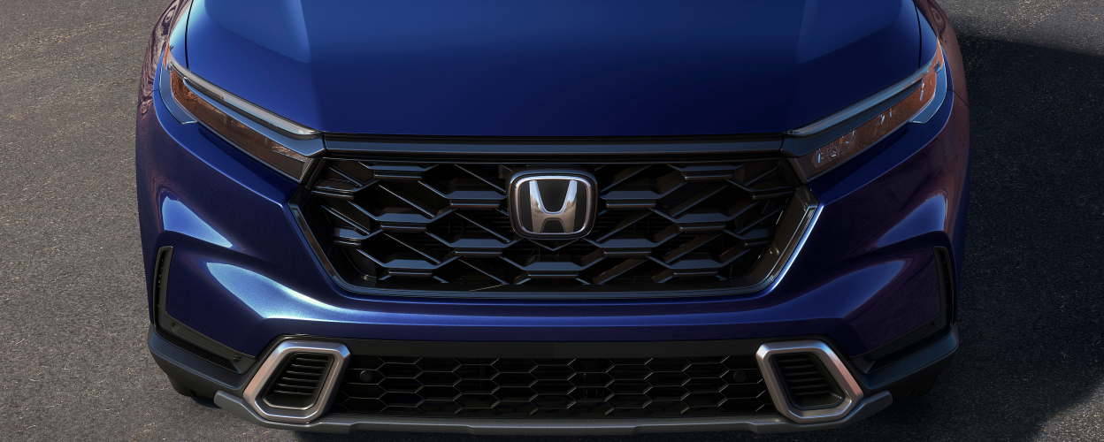 3/4 front bird’s eye view of honeycomb grille on a blue CR-V.