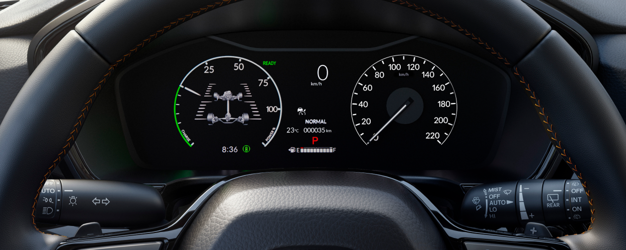 Closeup of TFT Display behind steering wheel, displaying speedometer, tachometer, etc.