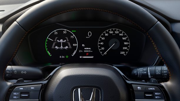 Closeup of TFT Display behind steering wheel, displaying speedometer, tachometer, etc.