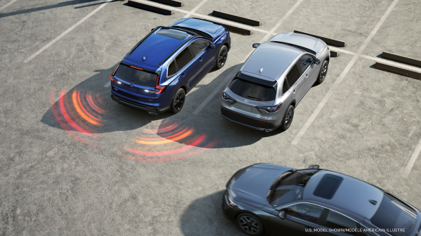 3/4 bird’s eye view of blue CR-V backing out of parking spot. Red/orange sensor waves emit from the back corners. 
