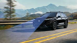 3/4 front view of black CR-V driving on forest highway with mountains in background. Blue sensor lines emit from the front.
