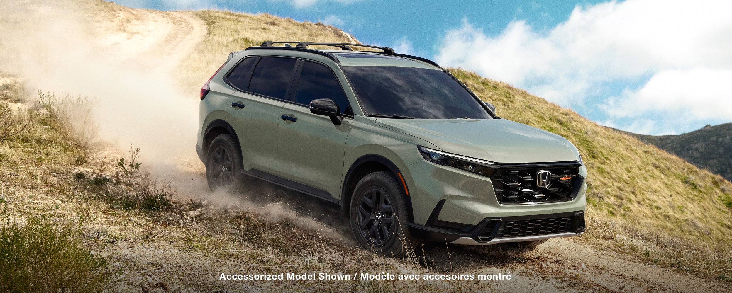 Side view of Green CR-V in a desert environment. 