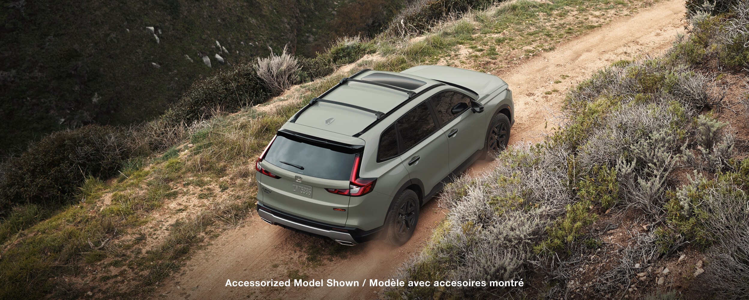 Birds eye view of a green CR-V on an outdoor road. 