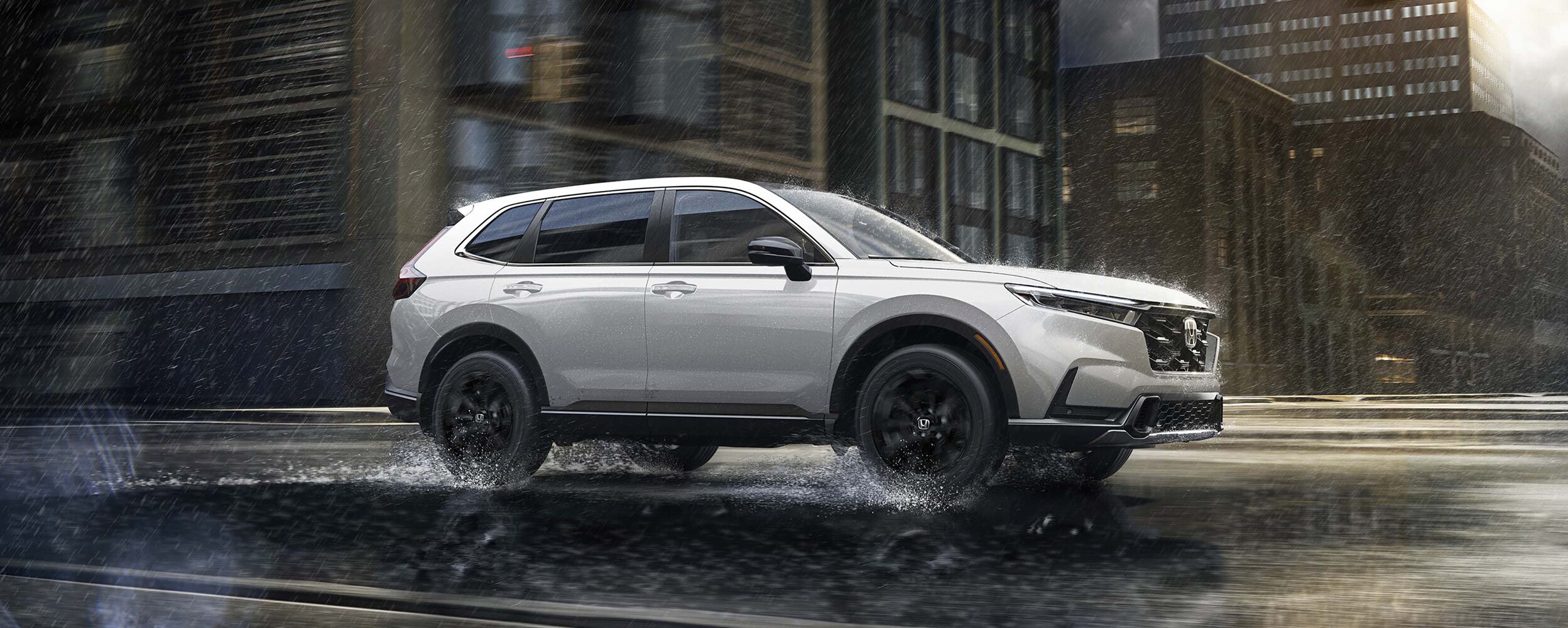 Side-view of a white CR-V driving in the city during daytime. 