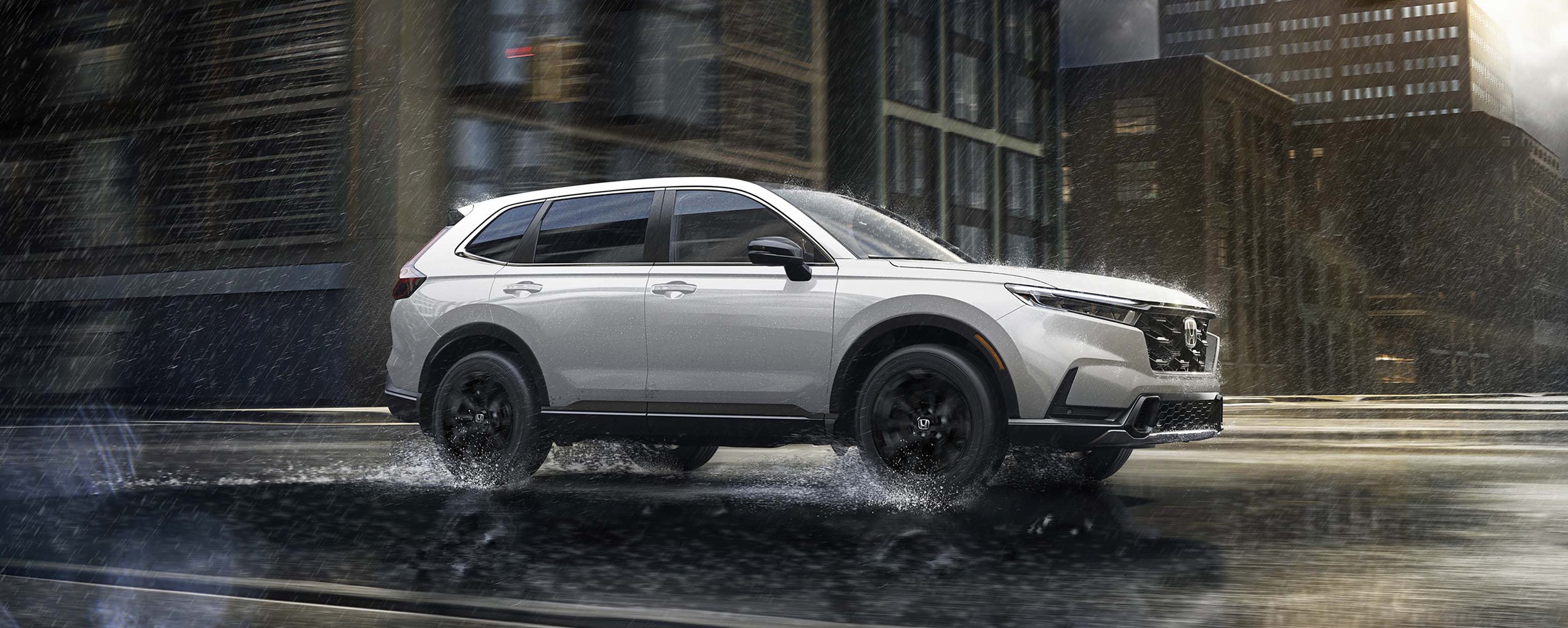 Side-view of a white CR-V driving in the city during daytime.