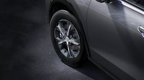 Closeup of front wheel on a grey HR-V. 