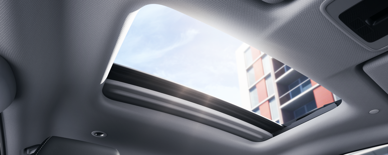 Interior view of open power moonroof letting in sunlight.