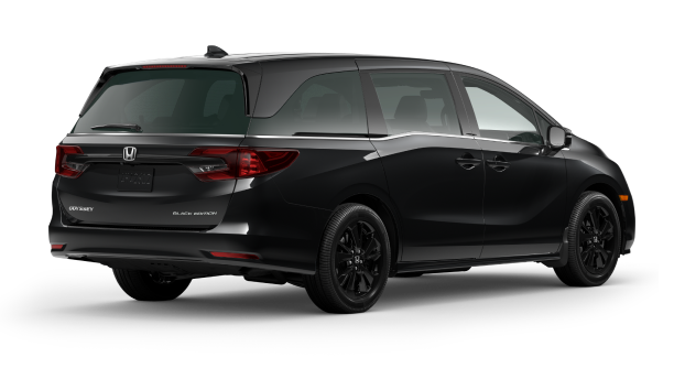 3/4 back view of black Honda Odyssey on white space.