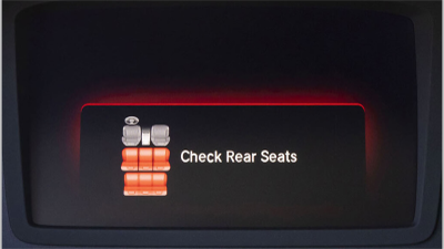 Closeup of “check rear seats” alert on screen.