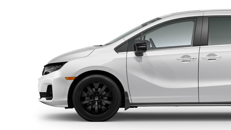 Vue latérale avant d’une Odyssey blanche sur fond blanc, montrant la roue avant.  