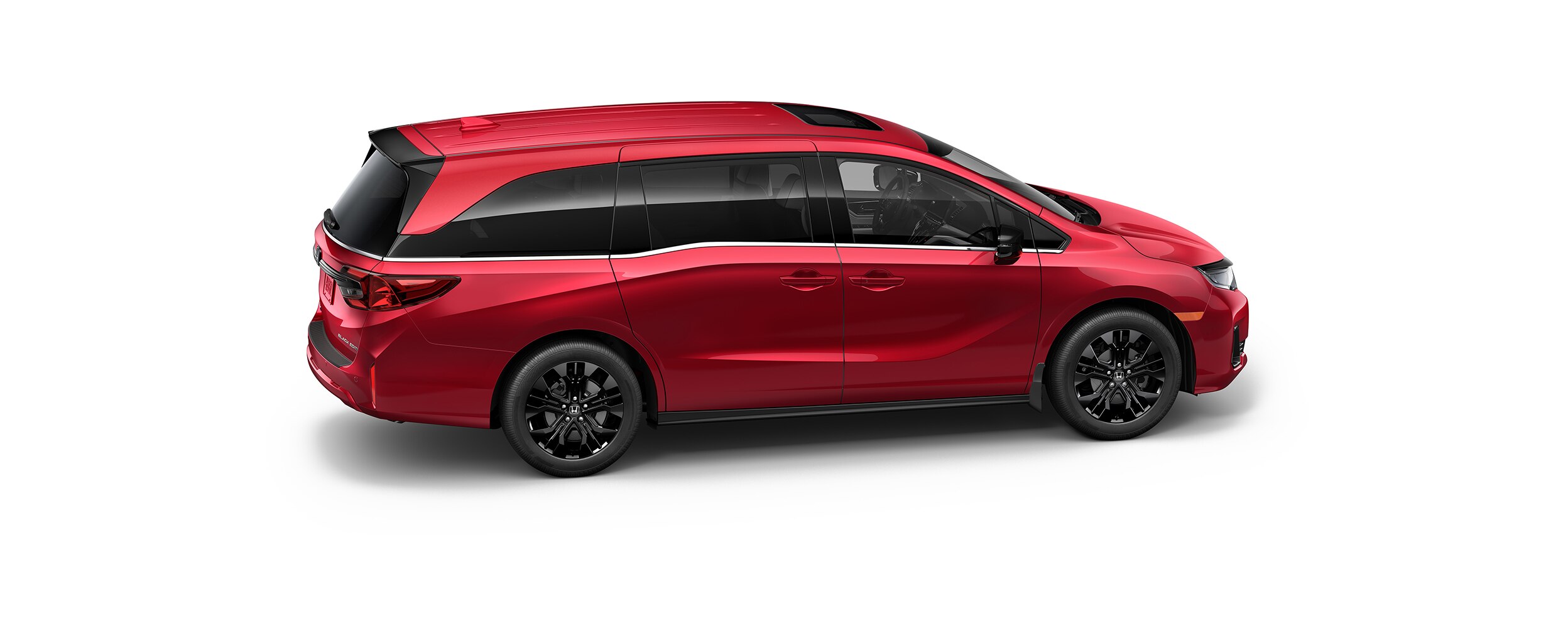 Vue latérale 3/4 en plongée d’une Odyssey rouge sur fond blanc.