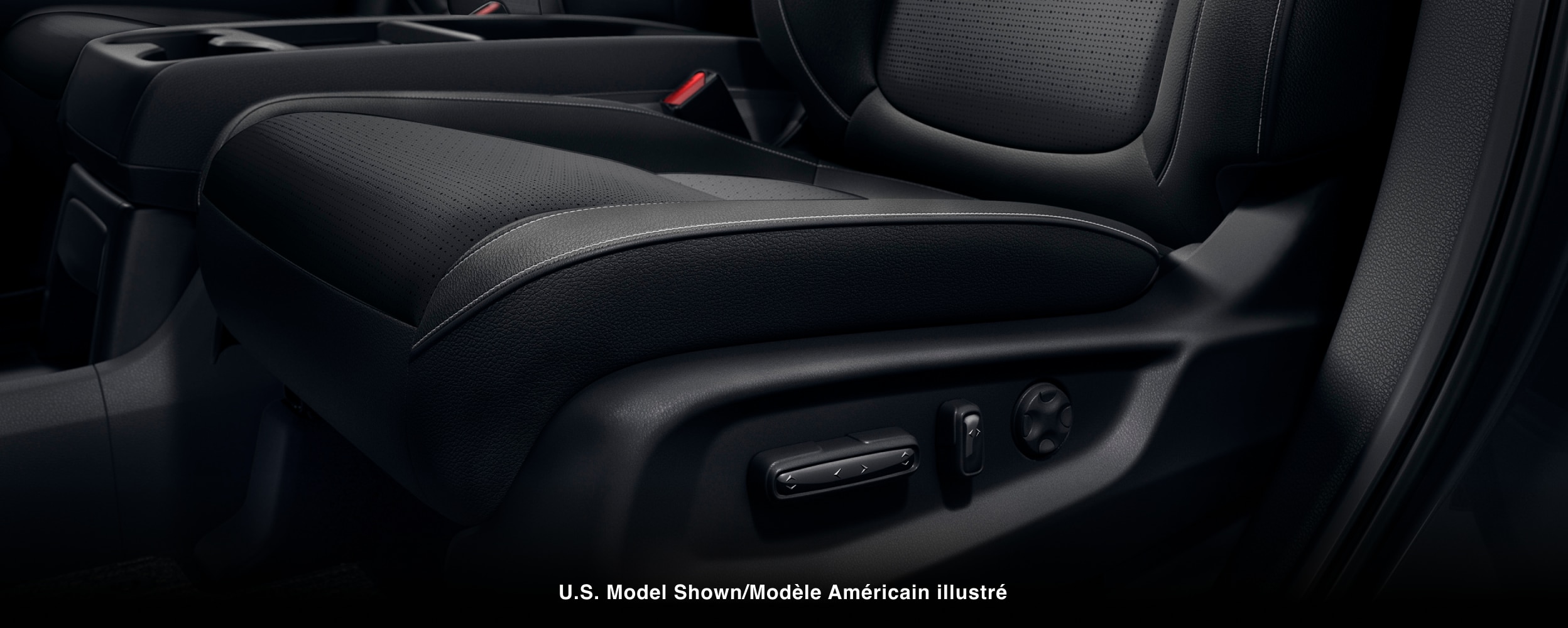 Closeup of power adjustment buttons on the side of a seat.