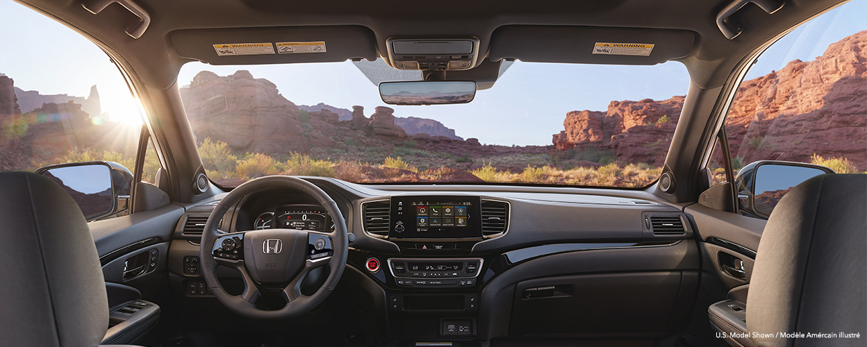 Panoramic interior view of front dashboard/console.