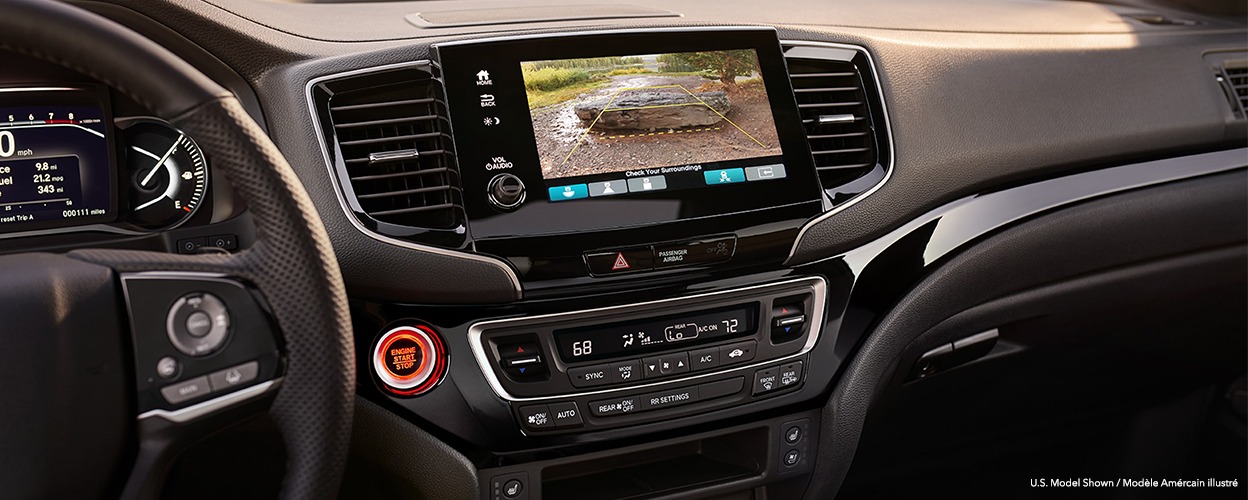 Closeup of centre console touchscreen projecting what the rear camera sees.