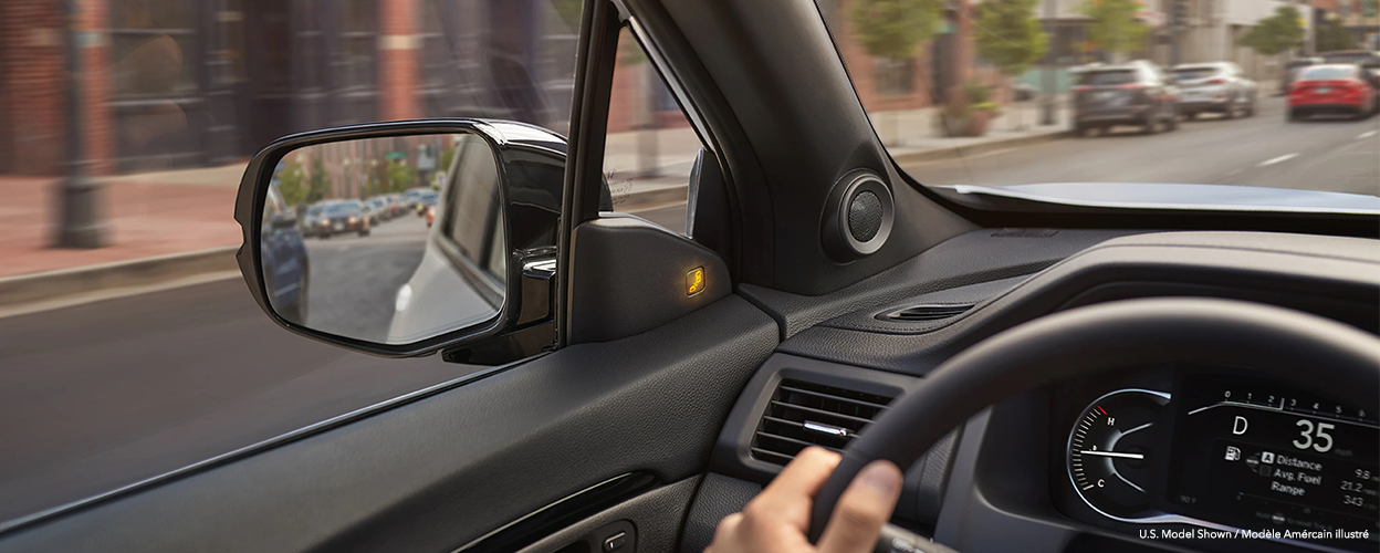 Closeup of side mirror, seen from the interior.